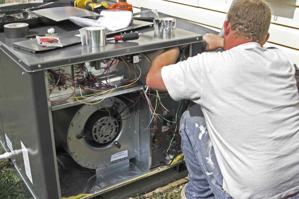 Heat Pumps vs Direct Electric Heating: Comparing Your Options for an All-Electric Home 4 hvac tech installing heat pump compressor