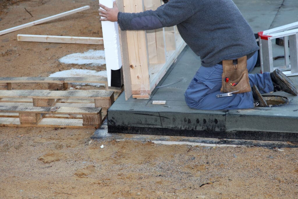 Thinking of Expanding? Here’s Why Prefab Additions Beat Traditional Builds 4 installing prefab home addition wall